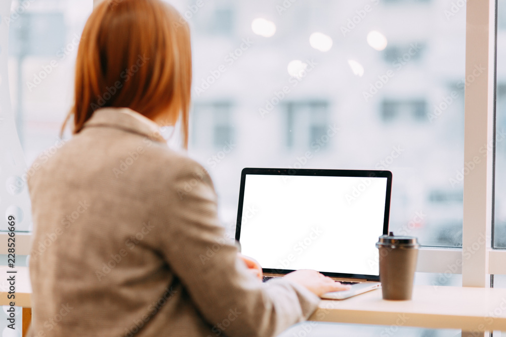 Hands with a laptop at work. Blogger at the coffee shop. White screen for designers. Business girl. Hands with a laptop at work. Blogger at the coffee shop. White screen for designers. Business girl.