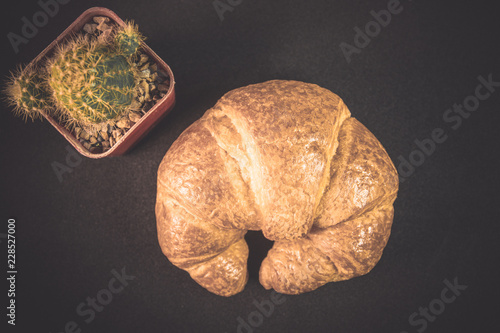 Tasty buttery croissants on old wooden table.