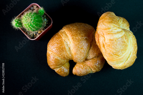 Tasty buttery croissants on old wooden table.