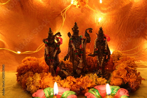 hindu god statues with flowers and diya on diwali
