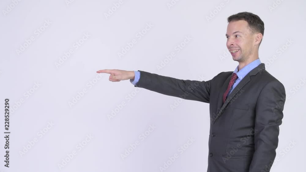 Profile view of happy businessman pointing finger Profile view of happy businessman pointing finger