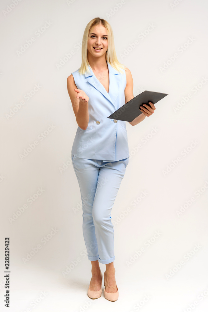 Studio photo of a beautiful blonde girl talking in a business suit on a white background. Studio photo of a beautiful blonde girl talking in a business suit on a white background.