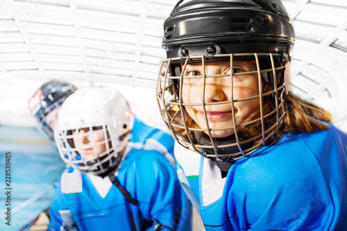Portrait of happy girl in ice hockey uniform