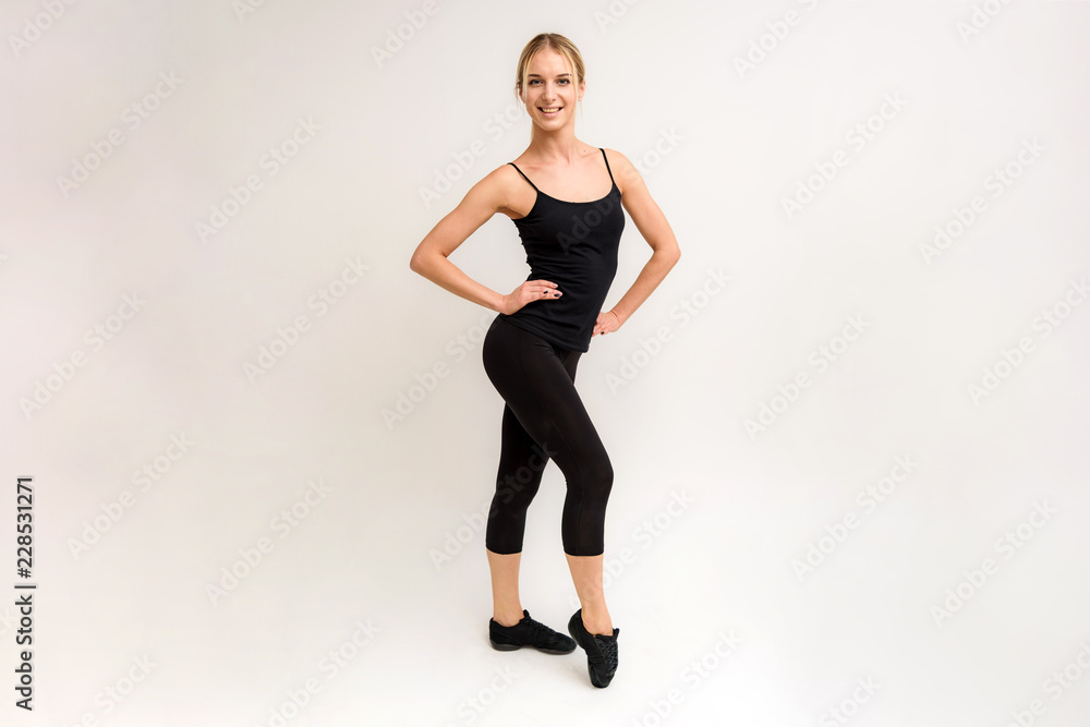 Studio photo of a beautiful blonde girl doing fitness stretching exercises on a white background. Studio photo of a beautiful blonde girl doing fitness stretching exercises on a white background.