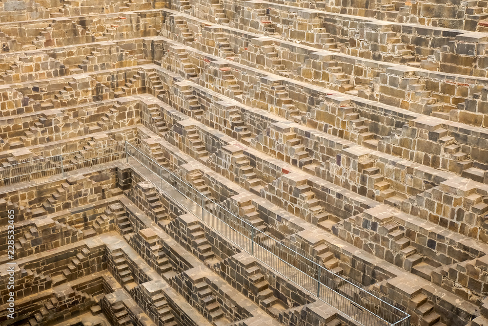 Step well Chan baori stairs detail in the Abhaneri village of Rajasthan, India. It is a stepwell built over a thousand years ago. Step well Chan baori stairs detail in the Abhaneri village of Rajasthan, India. It is a stepwell built over a thousand years ago.