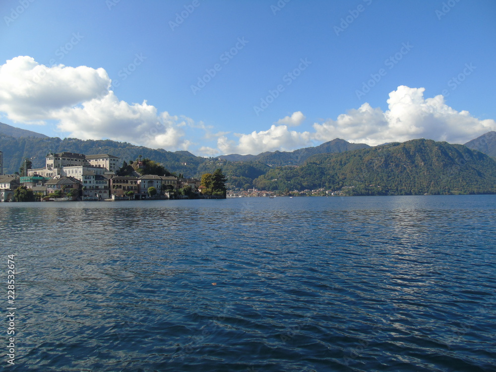 Fototapeta premium Amazing trip in Piemonte with an incredible view to the lake D'orta in autumn days and a caption of some old part of the countryside