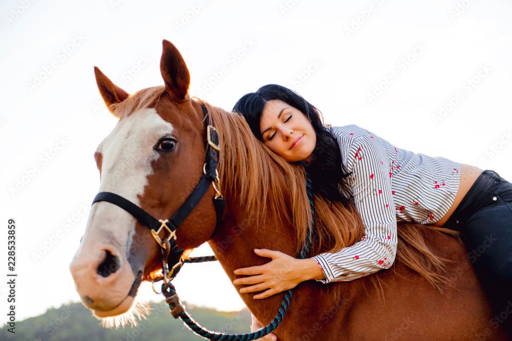 Obraz premium A Woman with her horse at sunset, autumn outdoors scene