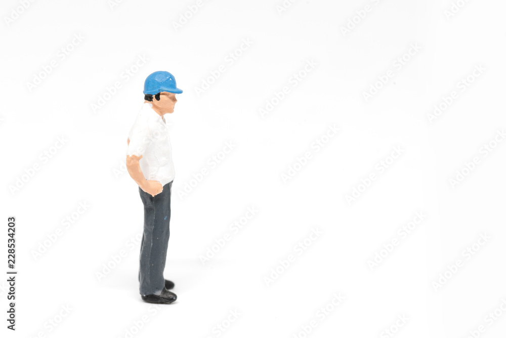 Miniature people worker safety construction concept on white background with a space for text