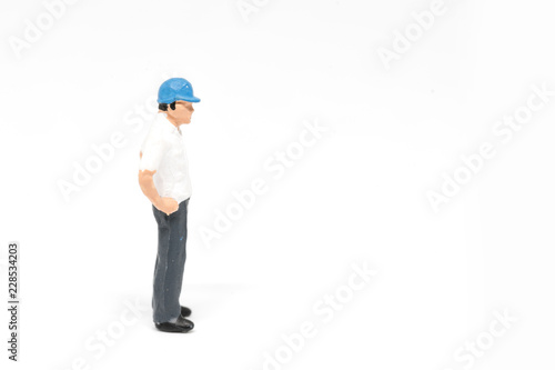 Miniature people worker safety construction concept on white background with a space for text © pigprox