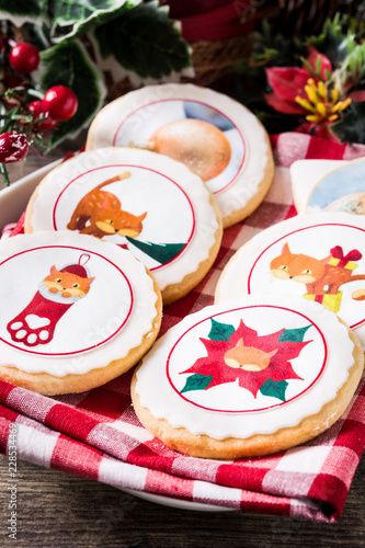 Christmas butter cookies decorated with Christmas graphics, on wooden table. Close up

