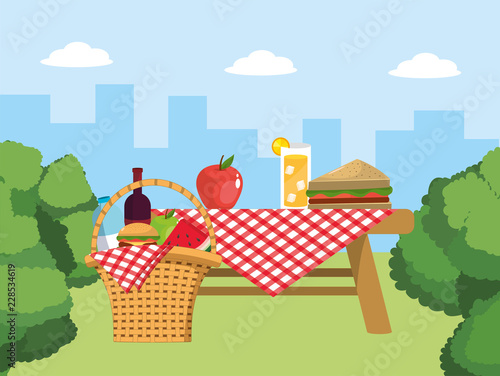 table and basket with food and tablecloth decoration photo