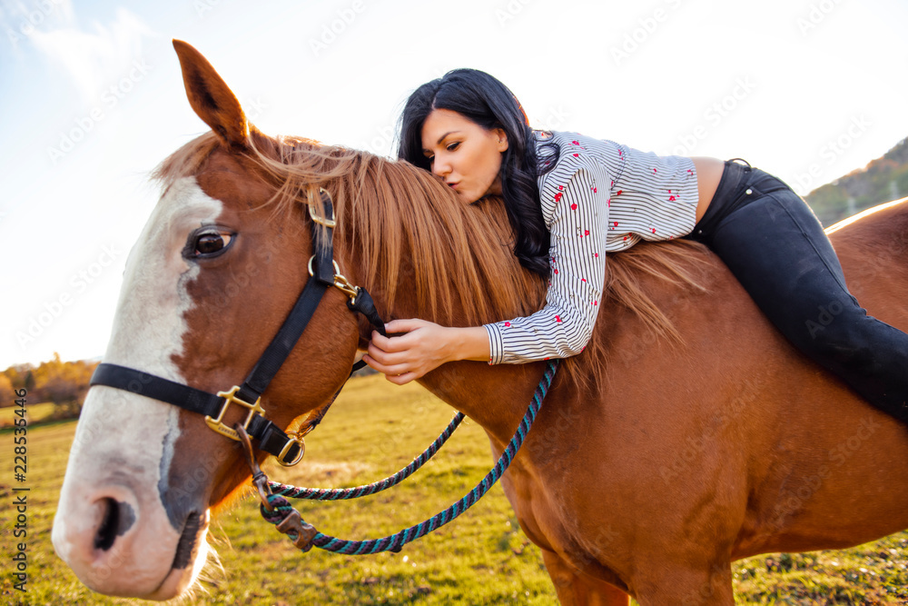 A Woman with her horse at sunset, autumn outdoors scene A Woman with her horse at sunset, autumn outdoors scene