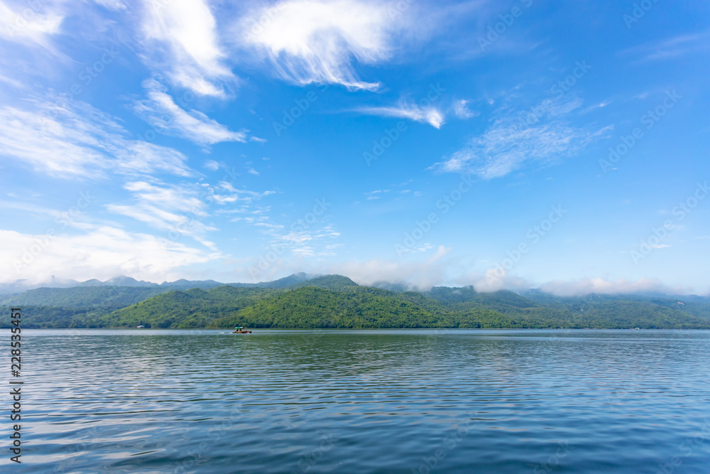 Landscape of the mountain and river with blue sky in the morning. View of the mountain with blue sky at Srinakarin Dam , Kanchanaburi province , Thailand. Landscape of the mountain and river with blue sky in the morning. View of the mountain with blue sky at Srinakarin Dam , Kanchanaburi province , Thailand.