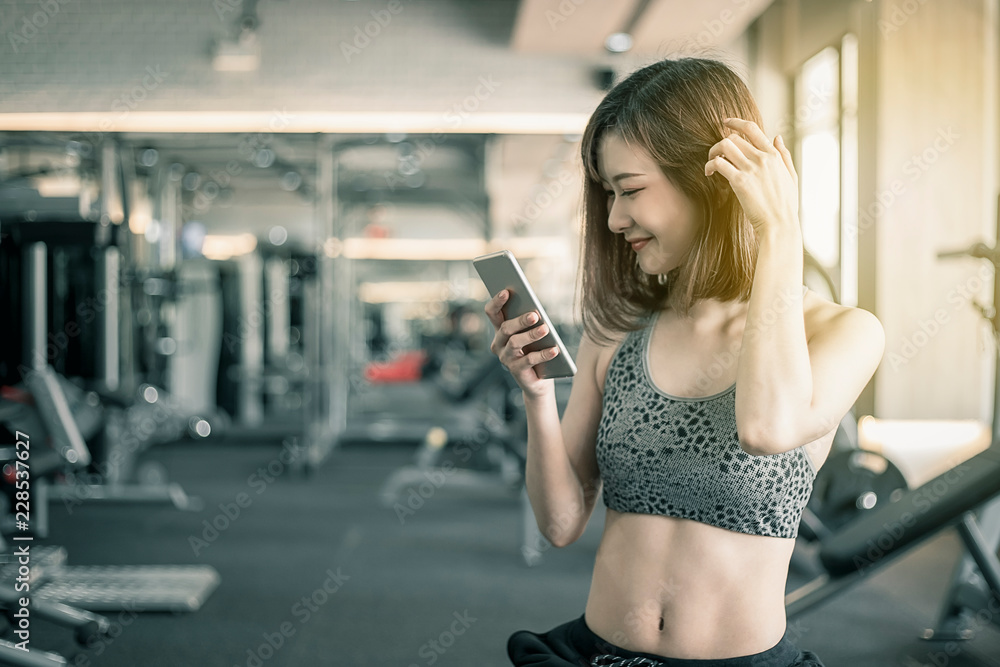 Woman with sport clothing exercise in the fitness gym. Modern women healthy lifestyle. 
