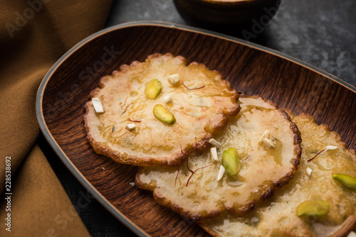 Malpua sweet - Traditional Indian dessert or pancake for festivals, served in plate with rabri/rabdi . selective focus