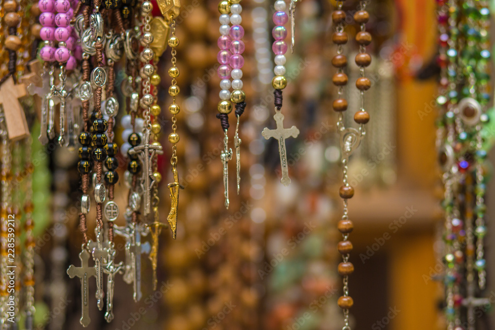 Christian cross and rosary colorful background.