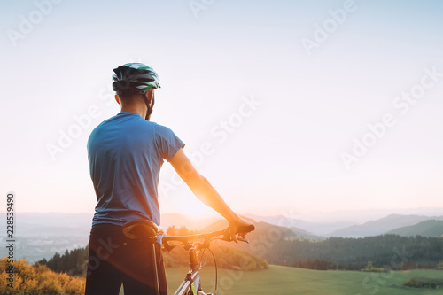 Man biker meets a sunset in mountain