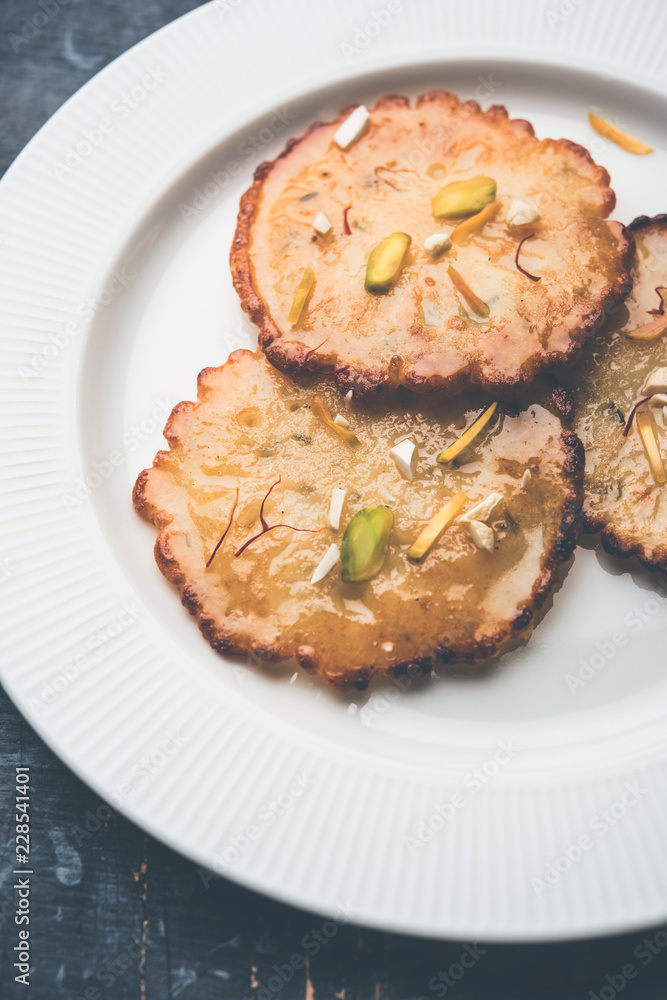 Malpua sweet - Traditional Indian dessert or pancake for festivals, served in plate with rabri/rabdi . selective focus