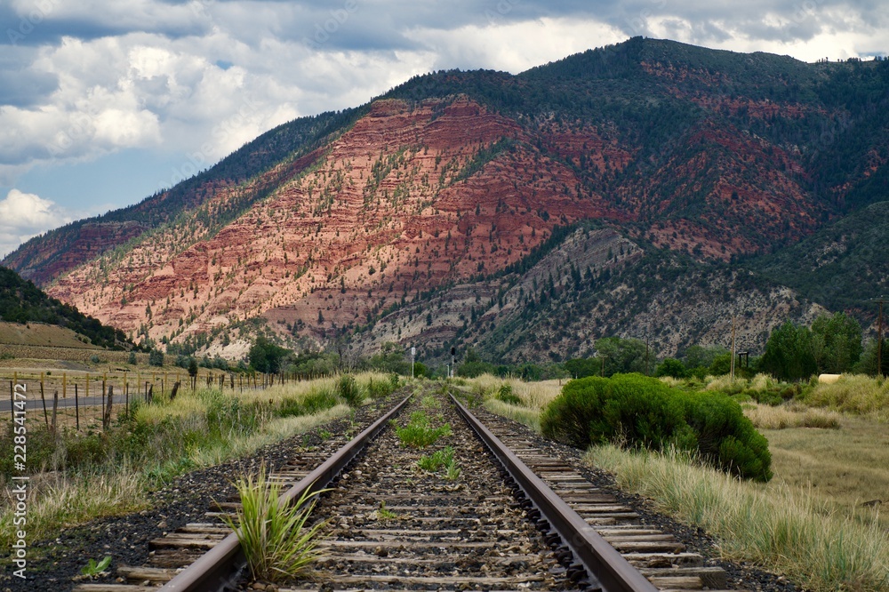 Railroad tracks and mountain in background
