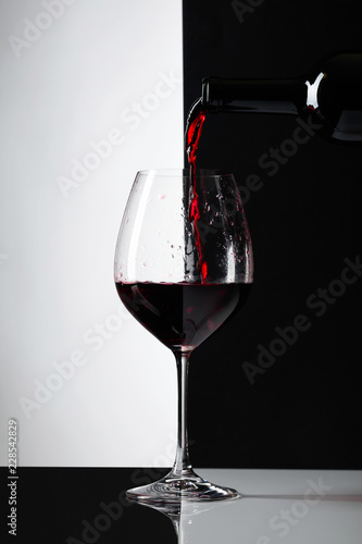 Red wine is poured into a glass.