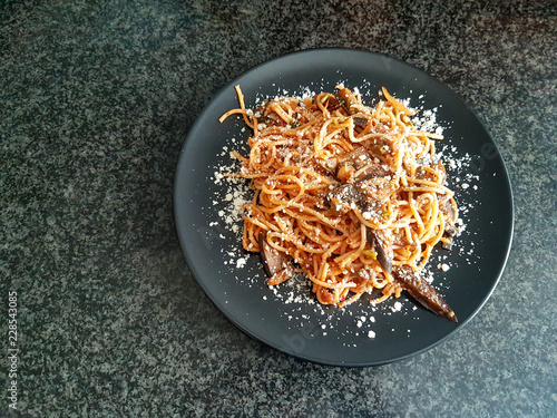 A tasty italian dish with spaghetti and vegetables.