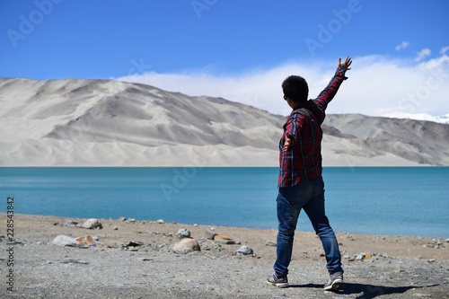 Sand dunes and turquoise blue water at Bulunkou lake on Karakoram Highway, Xinjiang photo