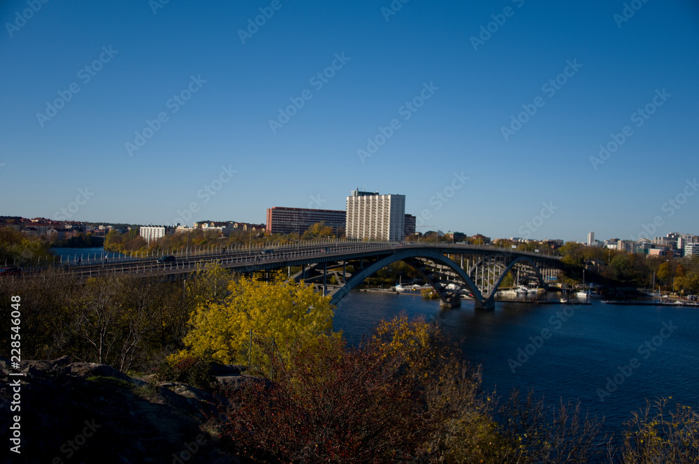 Bridge in Stockholm an autumn day blue sky and sea and orange leafs