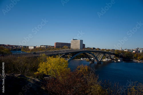 Bridge in Stockholm an autumn day blue sky and sea and orange leafs