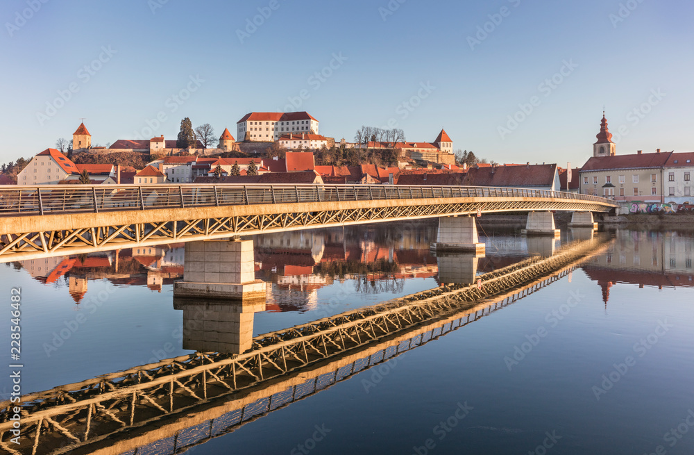 Modern bridge structure and its reflection in old town Ptuj, Slovenia