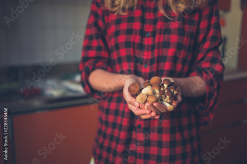 Young woman holding mushrooms