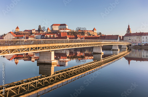 Fototapeta Naklejka Na Ścianę i Meble -  Modern bridge structure and its reflection in old town Ptuj, Slovenia