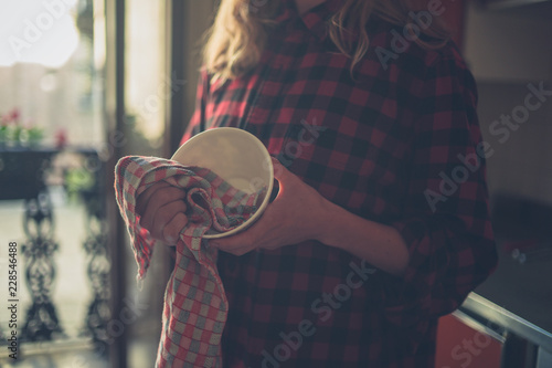 Young woman doing the dishes photo