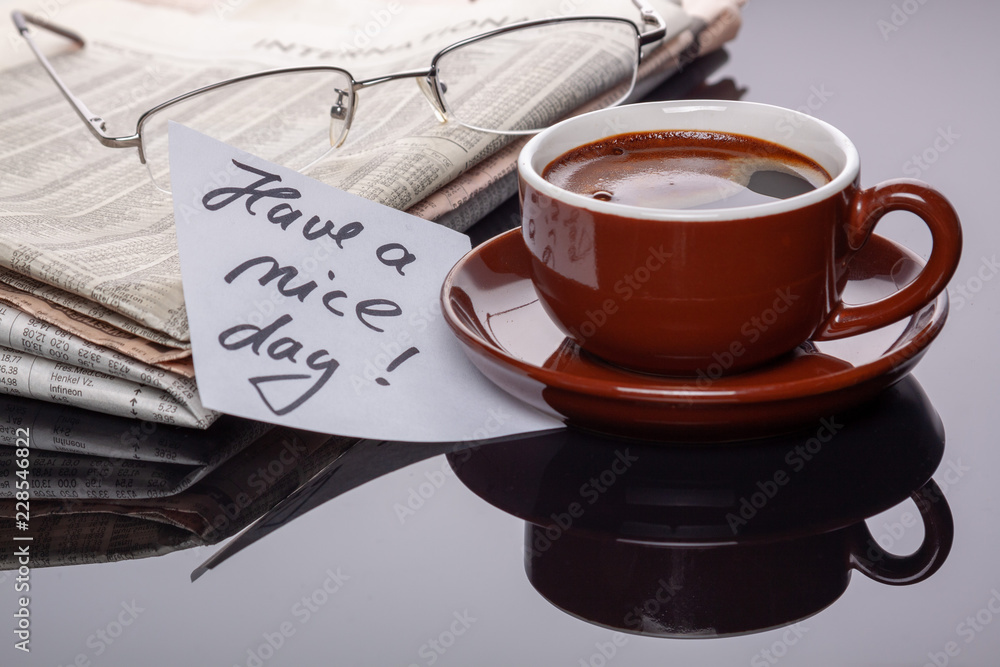 Cup of coffee with newspaper and note. Cup of coffee with newspaper and note.