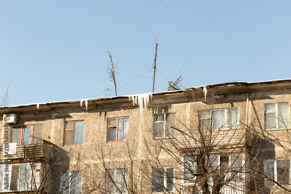 icicles which are hanging down from a roof