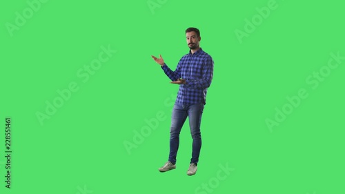 Young smart casual bearded modern man advertising and showing blank copy space. Full body isolated on green screen background. 