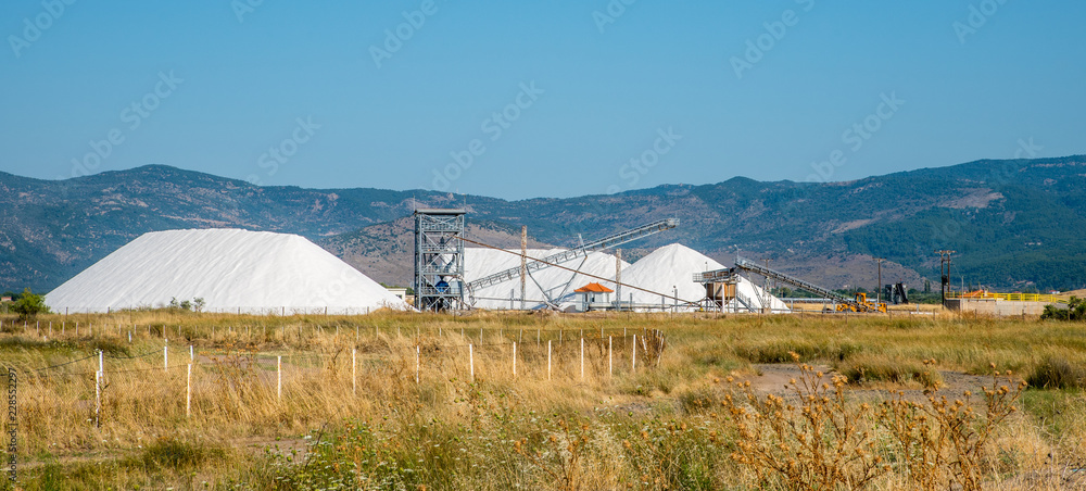 Mountains of salt being harvested with heavy machinery and conveyor belts Mountains of salt being harvested with heavy machinery and conveyor belts