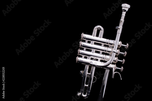 A silver plated piccolo trumpet on a black background photo