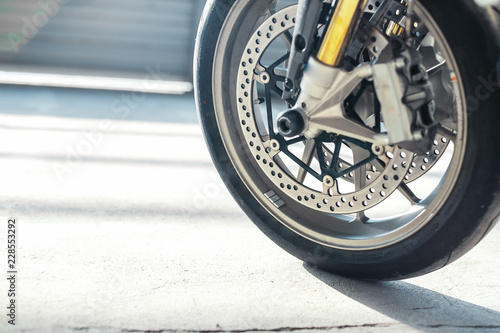 Close up of motorcycle wheel at parking.