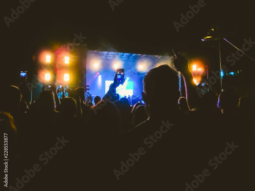 The party  concert concept. Crowd raising their hands and enjoying great rock festival. blur bokeh for background.