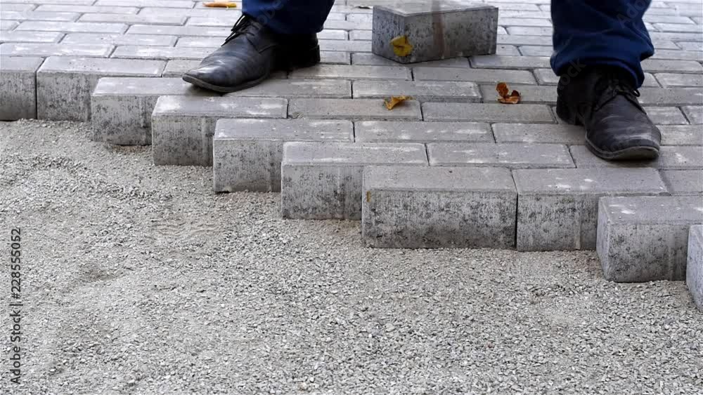 Laying paving slabs/Worker laying paving slabs on a city street Laying paving slabs/Worker laying paving slabs on a city street