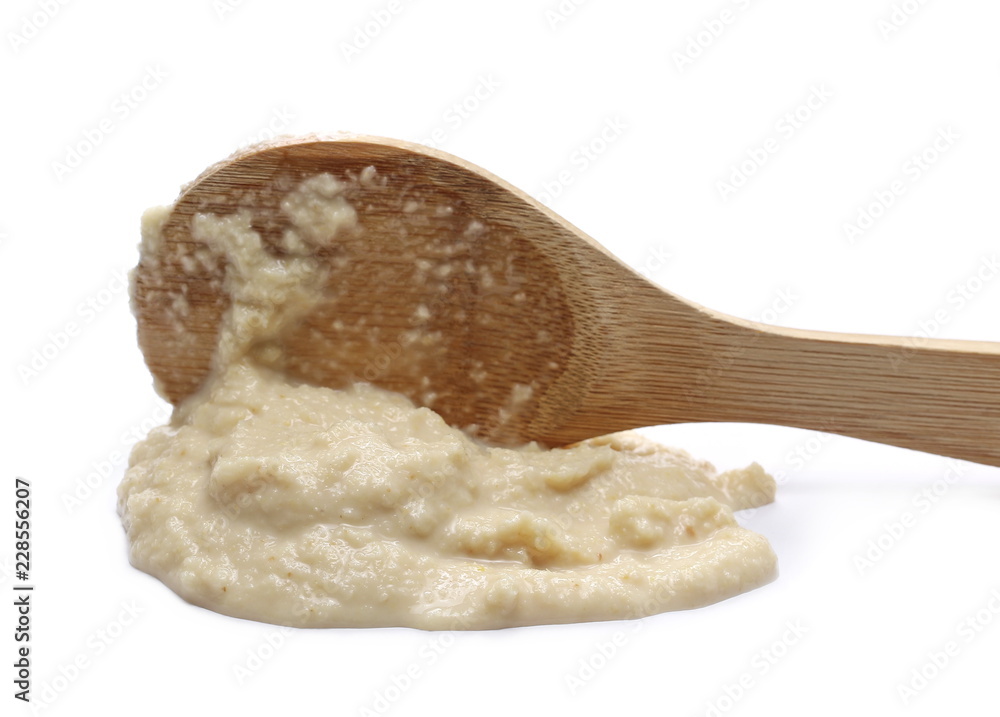 Horseradish sauce and wooden spoon, isolated on white Horseradish sauce and wooden spoon, isolated on white