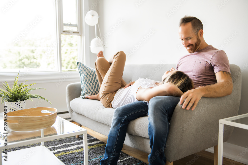 Young couple laying on the sofa relaxing at home Young couple laying on the sofa relaxing at home