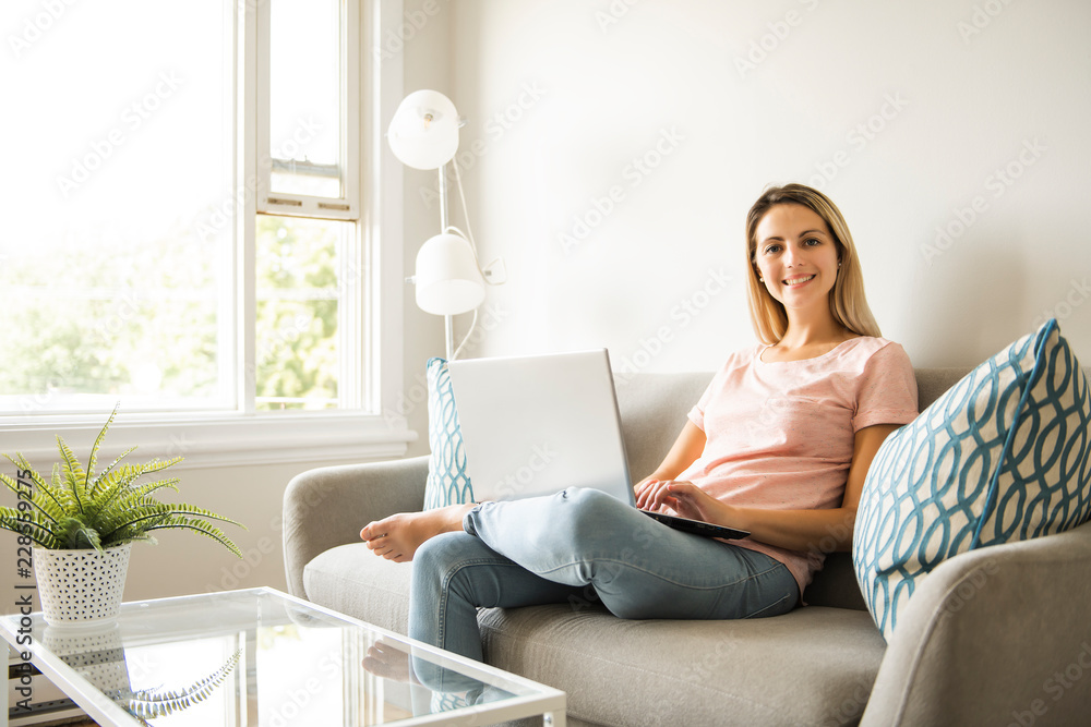 Fototapeta premium woman with a laptop on sofa at home