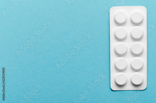 Blister of pills on blue background