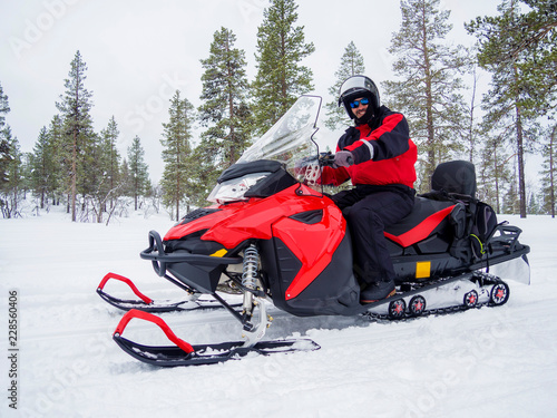 A Man on snowmobile in winter mountain