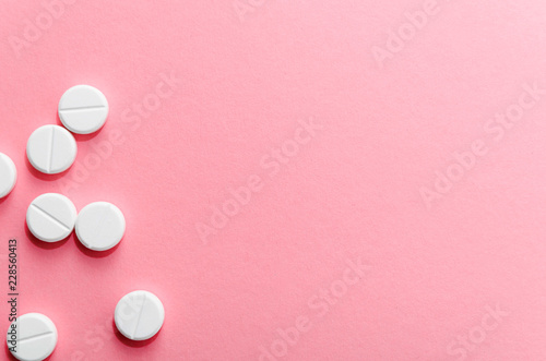  Close-up. A few pills on pink background