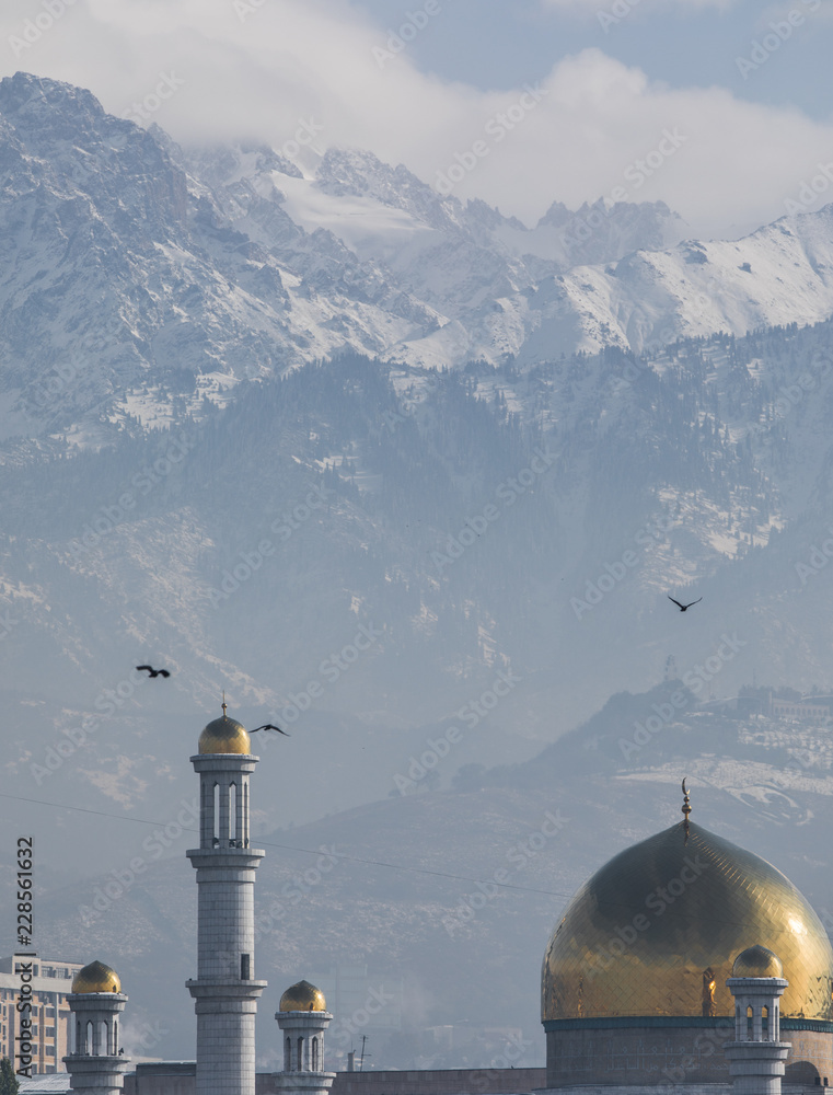 Mosque domes on the background of snowy mountains, Kazakhstan, Almaty