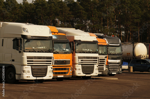 Wallpaper Mural Service plaza. A row of trucks in a parking lot near the freeway during a travel break. Torontodigital.ca