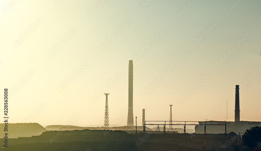 evening landscape of metallurgical plant with high pipes evening landscape of metallurgical plant with high pipes