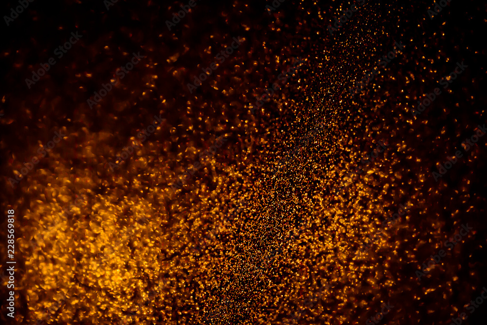 Abstract bokeh glitter background. Defocused background. Blurred bright light on black